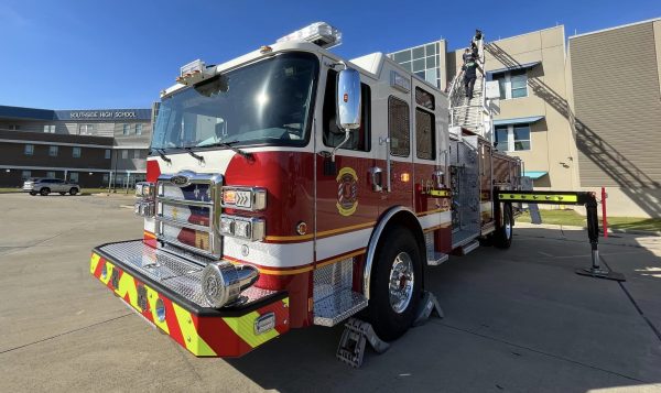 Front view of ladder truck with ladder extended