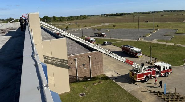 YFD ladder truck with ladder extended to the top of a building